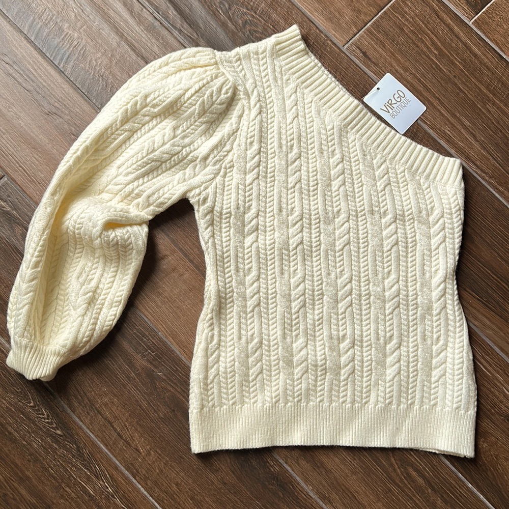 Large cream colored one shoulder sweater. Brand new with tags.